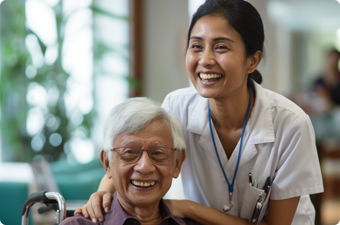 Nurse smiling while assisting an elderly patient